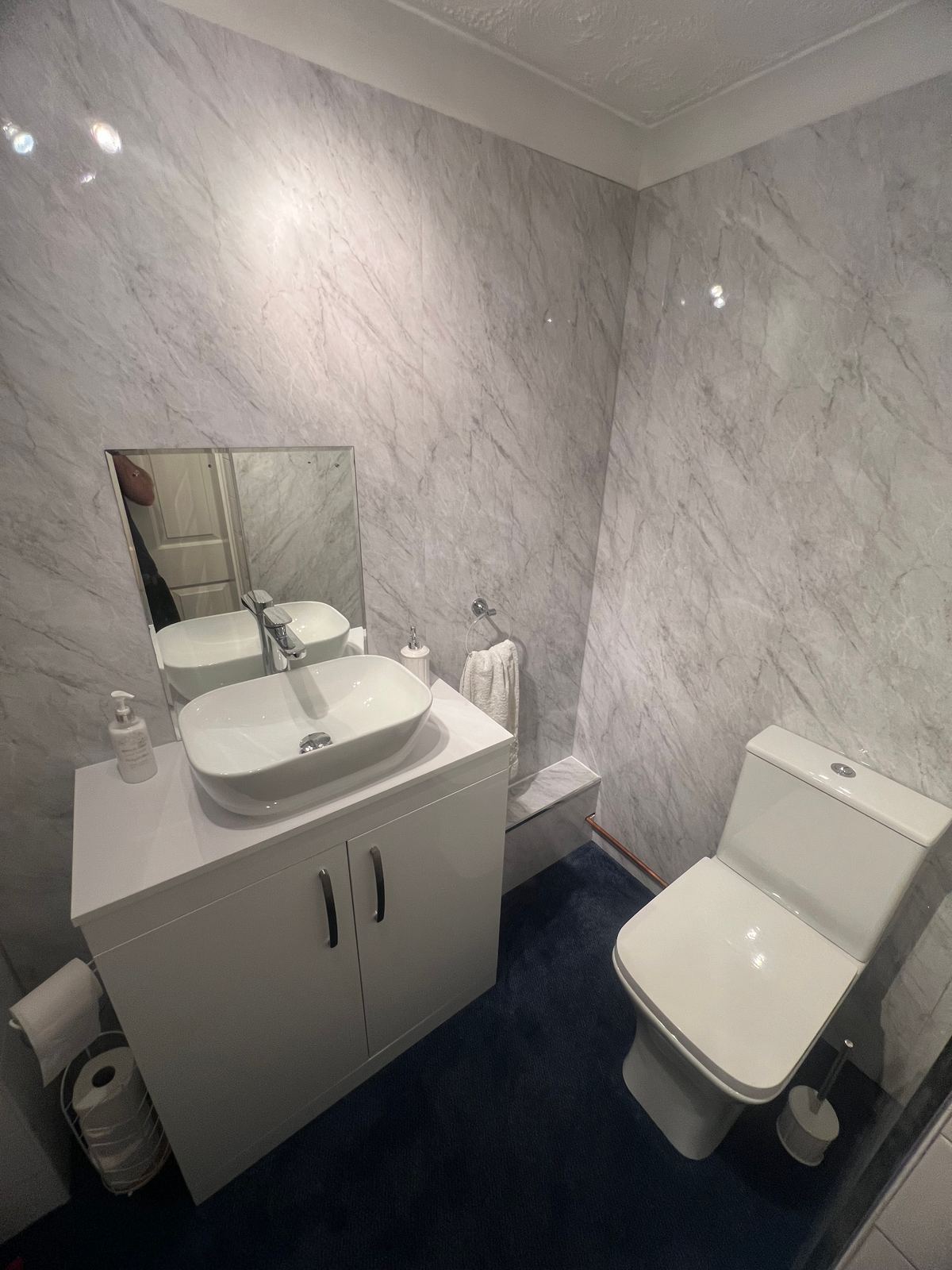 Cloakroom finished in marble effect wall panels