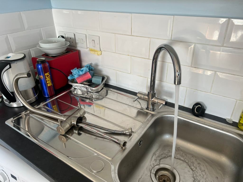 New kitchen mixer tap running, the old one on the drainer