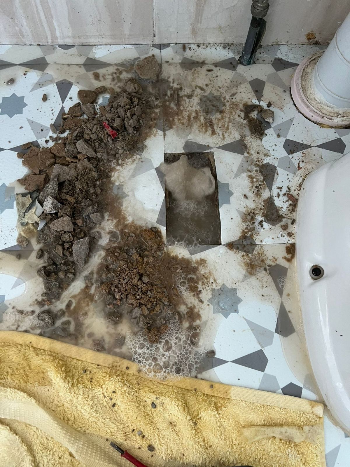 Bathroom floor opened up to reach a leak in the pipework beneath