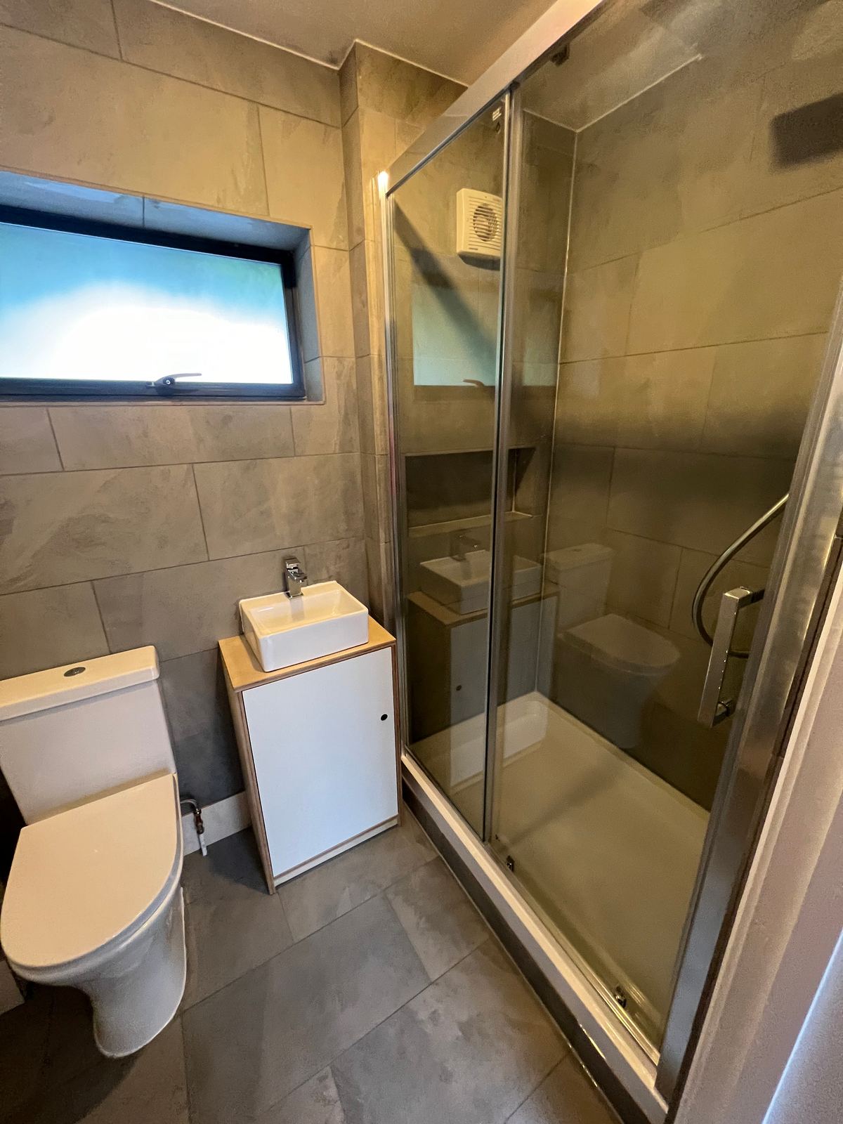 Finished shower room with sliding enclosure
